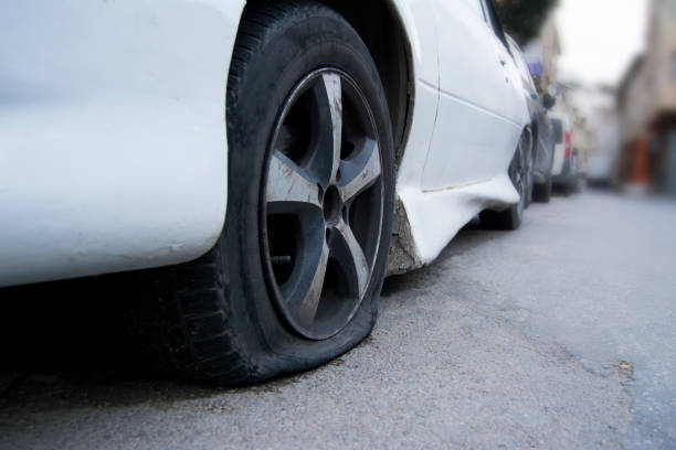 istock Old car flat tire on way 941319886