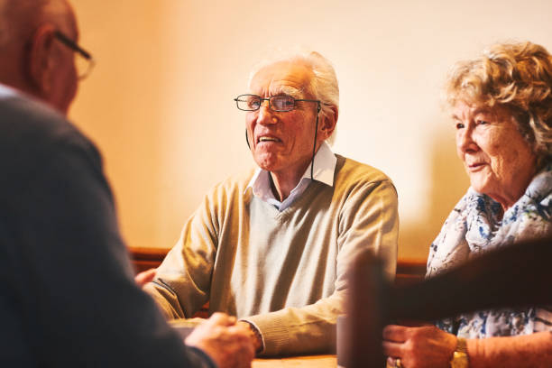 istock Senior man talking with friends at nursing home 941321084