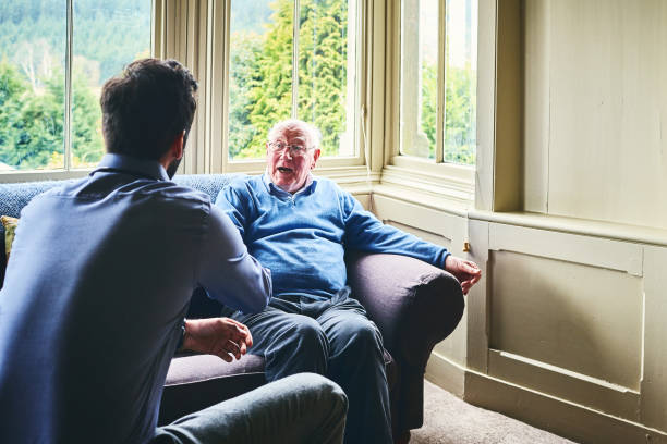 istock Senior man talking with doctor at care home 941321196