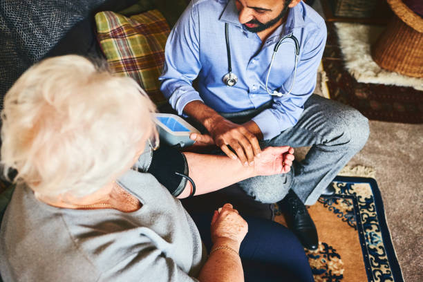 istock Medic visiting senior woman for regular check up 941321262