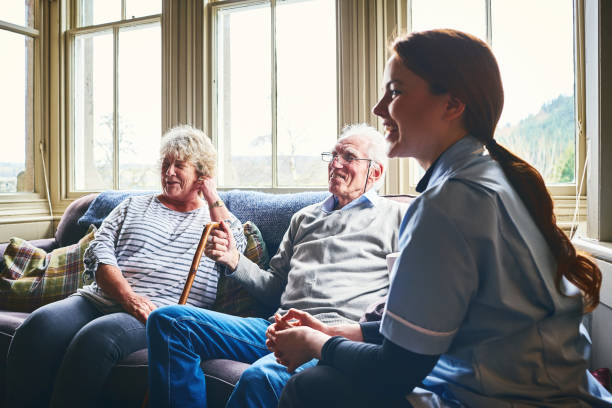 istock Smiling nurse visiting senior people at home 941321362