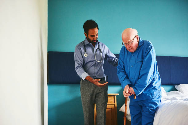 istock Doctor assisting senior patient to walk 941321486