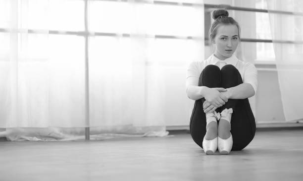istock Young ballet dancer on a warm-up. The ballerina is preparing to 941326042