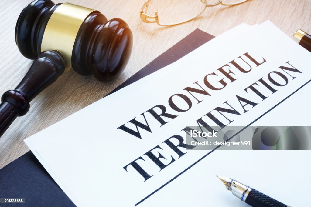 Documents about wrongful termination and gavel. Finishing Stock Photo