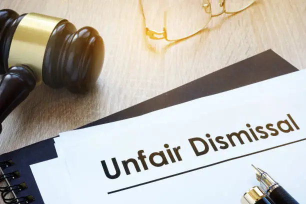 Documents unfair dismissal and gavel in a court.
