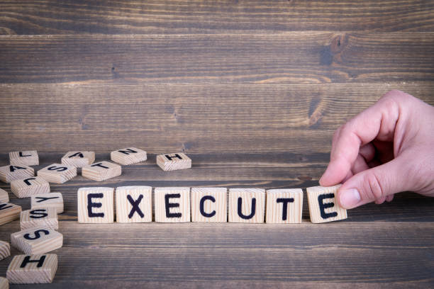 Execute. Wooden letters on the office desk, informative and communication background