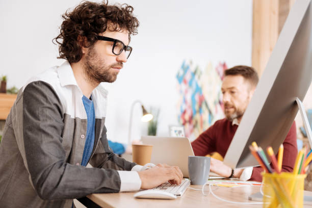 istock Serious young employee working in the office 941339172