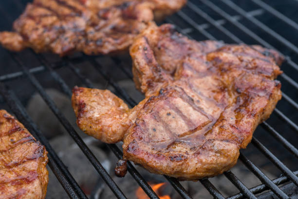 istock pork steak meat on bbq grill 941339252
