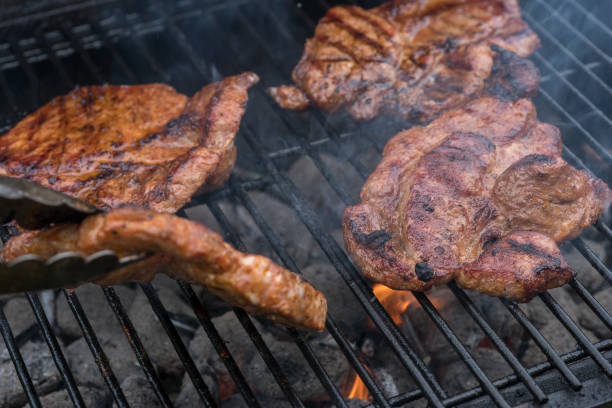 istock pork steak meat on bbq grill 941339540