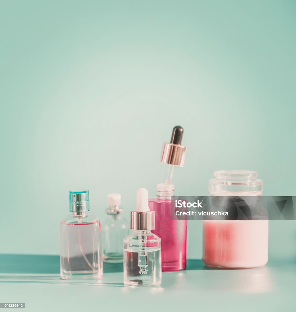 Set of modern facial skin care cosmetics at blue background Set of modern facial skin care cosmetics at blue background Product bottles with dropper and pipette, mist spray , serum and moisturizing in glass jar. Front view. Branding mock-up Beauty Stock Photo
