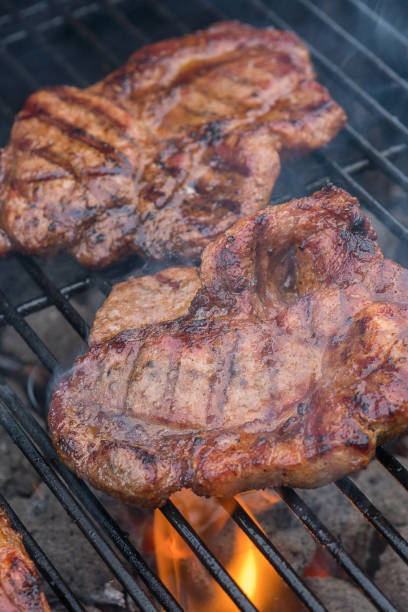istock pork steak meat on bbq grill 941339568