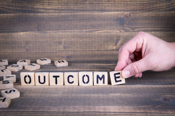 istock Outcome. Wooden letters on the office desk 941346510
