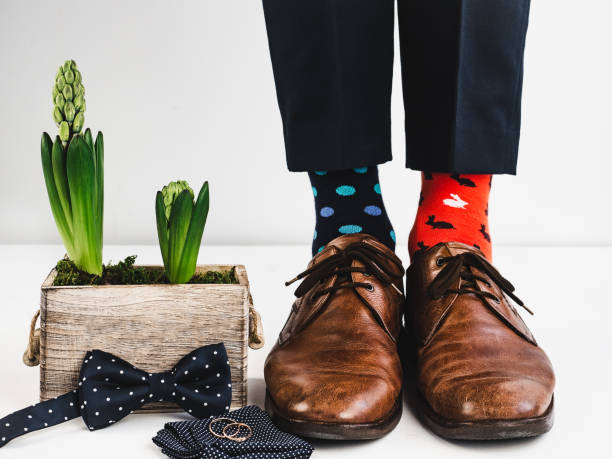 istock Groom, funny socks, rings, flower and bow tie 941347164
