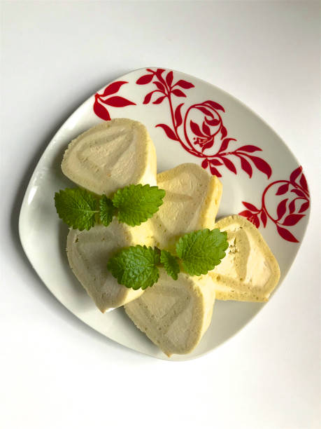 istock Preparation of biscuit rolls. On the table stand a plate with a ready sliced roll, decorated with lemon bald leaves. 941364136