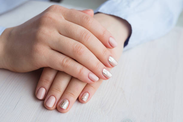 istock Female hands with manicure and pink polished nails 941373064