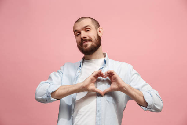 Portrait of attractive man with kiss isolated over pink background I love you. Portrait of attractive man at pink studio. Beautiful male portrait. Young happy emotional funny man looking at camera. Human facial emotions concept. Trendy colors blowing a kiss stock pictures, royalty-free photos & images