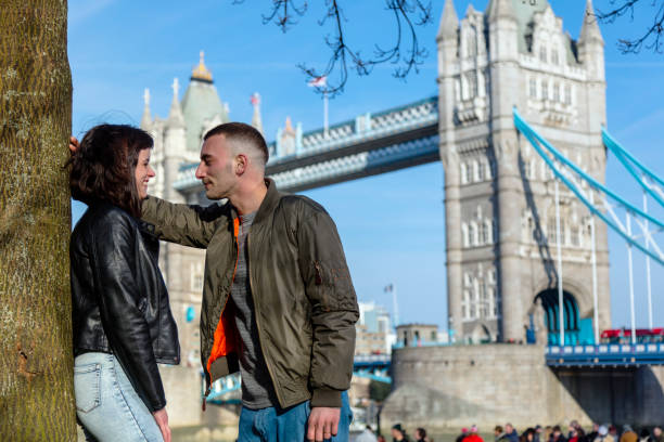 istock Sweet couple relaxing along the Thames river 941374946
