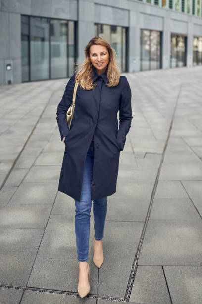 istock Attractive woman in jeans and an overcoat 941381638