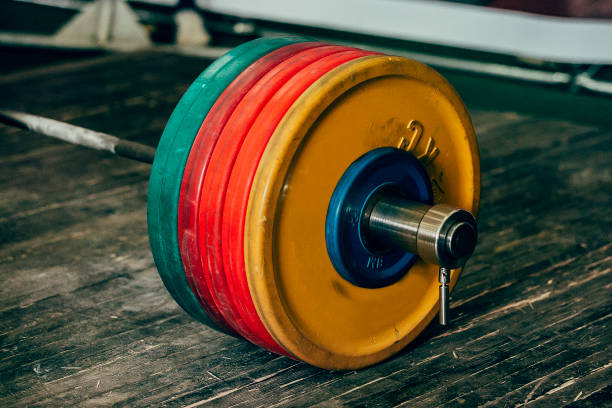 heavy barbell with five plates heavy barbell with five plates for deadlift on wooden floor powerlifting stock pictures, royalty-free photos & images