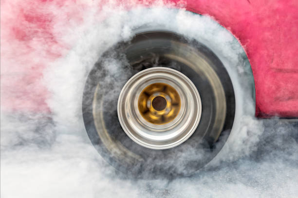 istock Drag racing car burn tire at start line 941382502