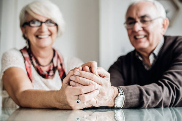 istock Elderly couple holding hands 941387900