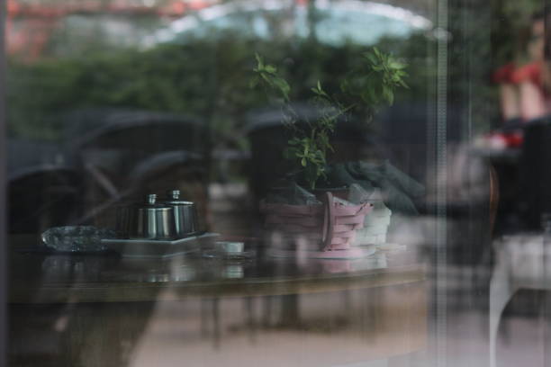istock Small city cafe tables with flowers 941388172