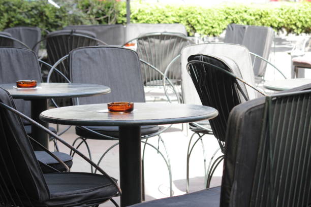 istock Small city cafe tables with flowers 941388182