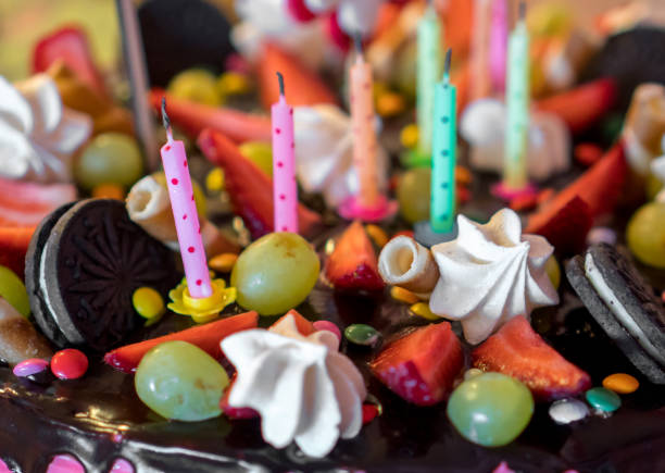 istock Pink chocolate cake with strawberries, meringues and grapes. 941392106