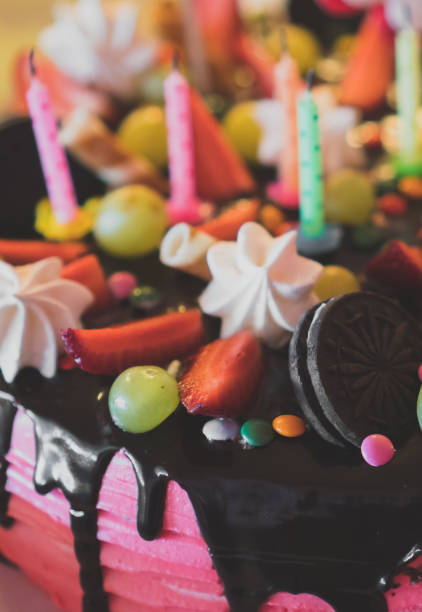 istock Pink chocolate cake with strawberries, meringues and grapes. 941392138