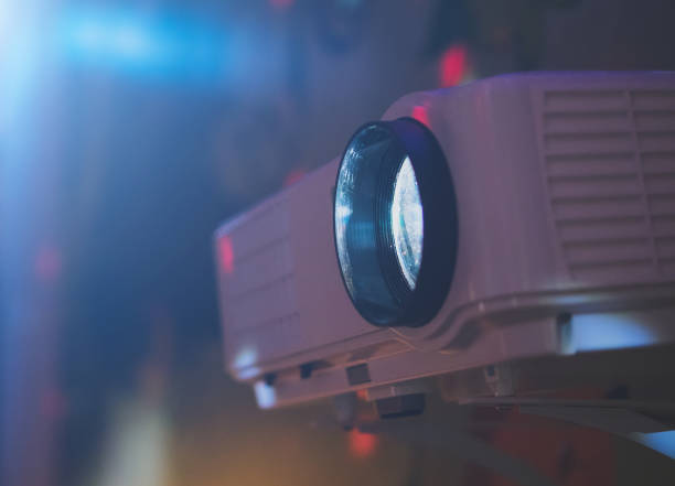 istock Movie projector in action mounted on the wall. 941392162