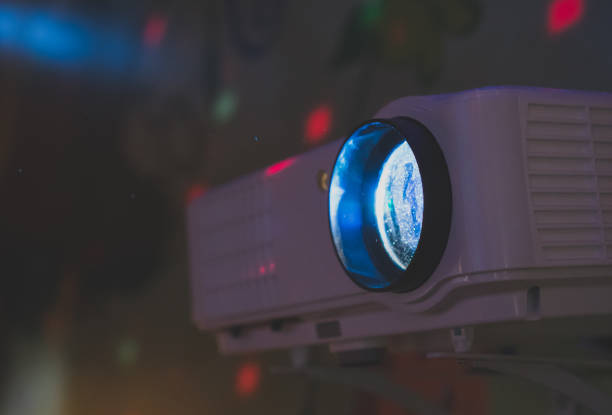 istock Movie projector in action mounted on the wall. 941392166