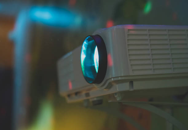 istock Movie projector in action mounted on the wall. 941392180