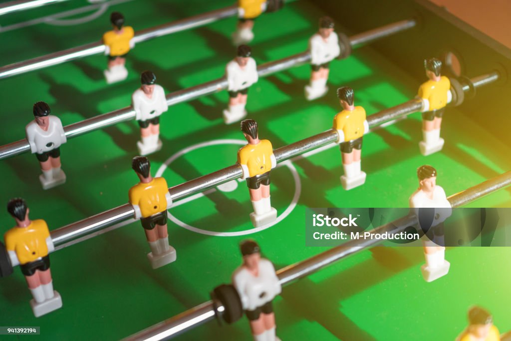 Table football game with yellow and white players. Agricultural Field Stock Photo