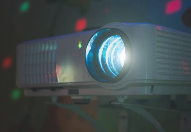 istock Movie projector in action mounted on the wall. 941392202