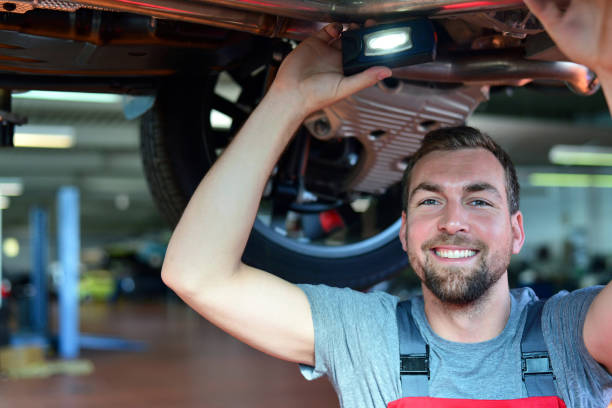 istock Auto mechanic repairs vehicle in a workshop 941393172