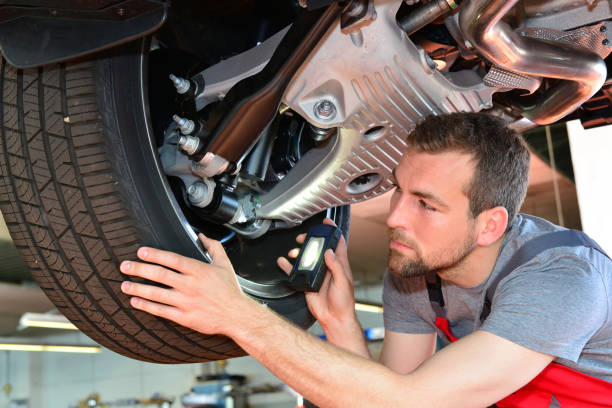 istock Auto mechanic repairs vehicle in a workshop 941393298