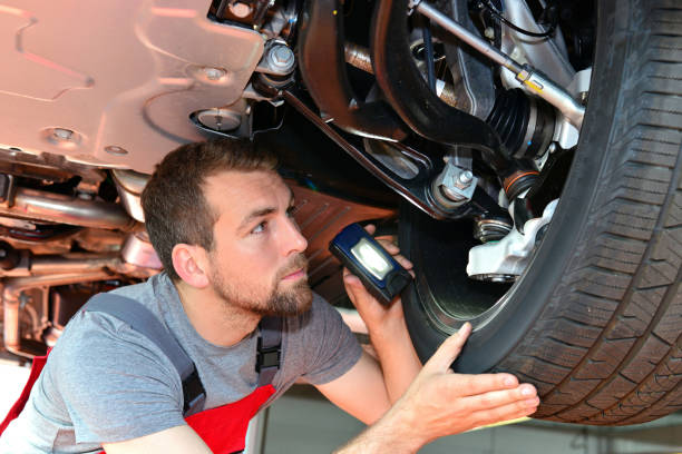istock Auto mechanic repairs vehicle in a workshop 941393394