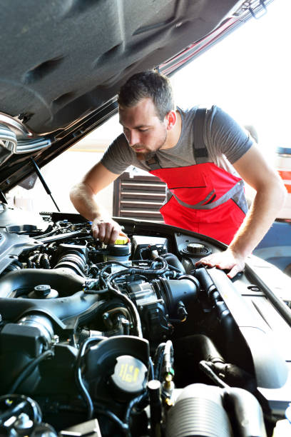 istock Auto mechanic repairs vehicle in a workshop 941395796