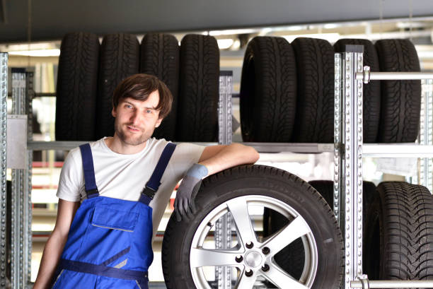 istock workers in a warehouse with tyres for changing the car 941396842