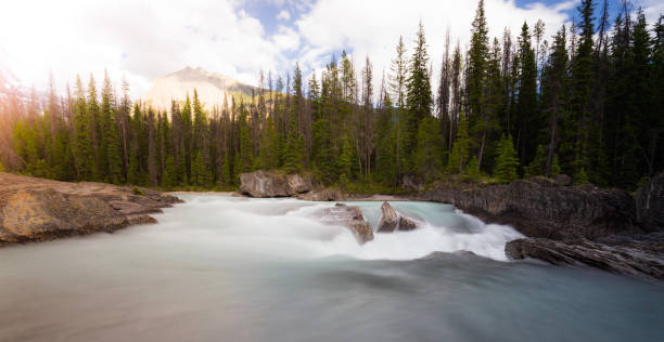 istock Waterfalls long exposure with sun flare, Rocky mountains in Canada 941403796