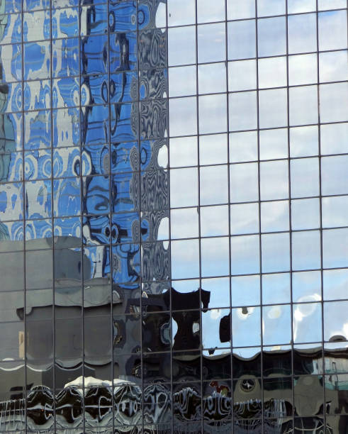 istock buildings and clouds reflected from the glass 941404312