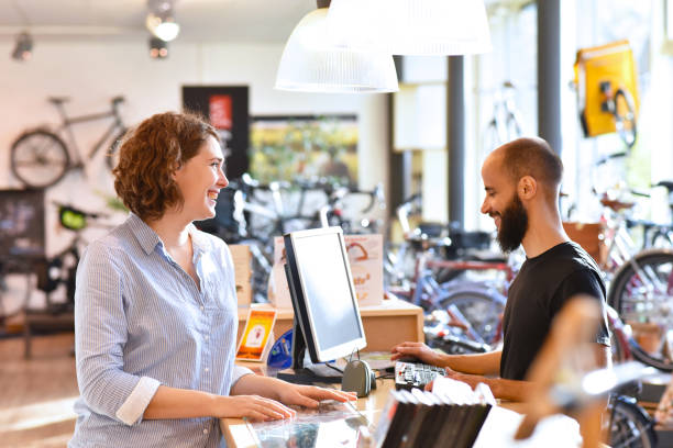 istock Bicycle shop consulting - salesman and customer in conversation 941404394
