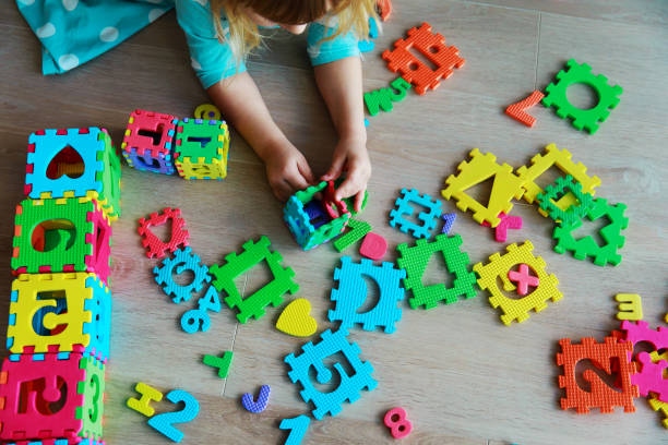 istock little girl learning numbers and shapes, play with puzzle 941407548