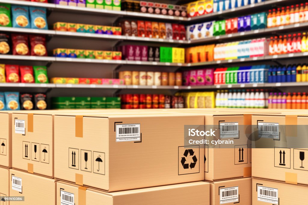 Distribution warehouse logistics, packaged parcels ready for shipment and delivery Stack of cardboard boxes in a retail store on the background of shelves with goods Merchandise Stock Photo