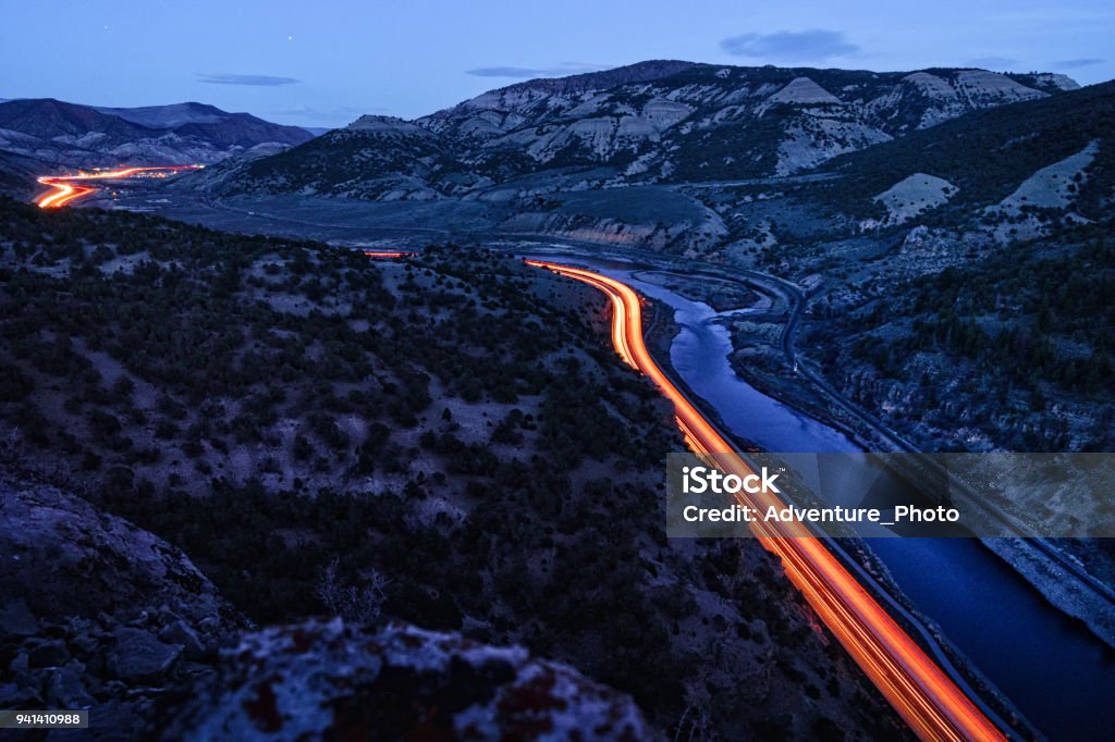 Glenwood Canyon I-70 Curves at night Dusk View Glenwood Canyon I-70 Curves at night Dusk View - Transportation and Interstate freeway going through scenic canyon with automobile light trails. Colorado Stock Photo