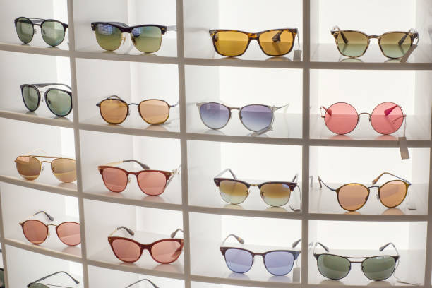 Various different sunglasses in the shop display shelves