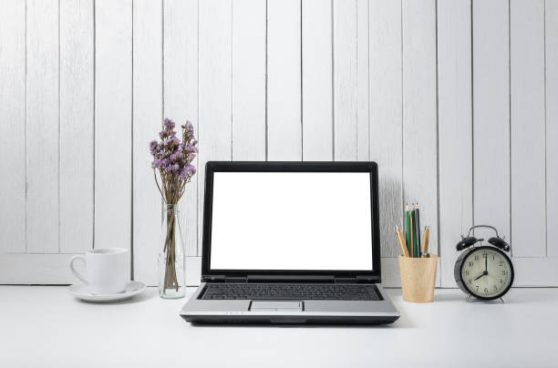 istock workplace background with Blank white screen modern laptop computer. White wooden vintage blackground 941411856