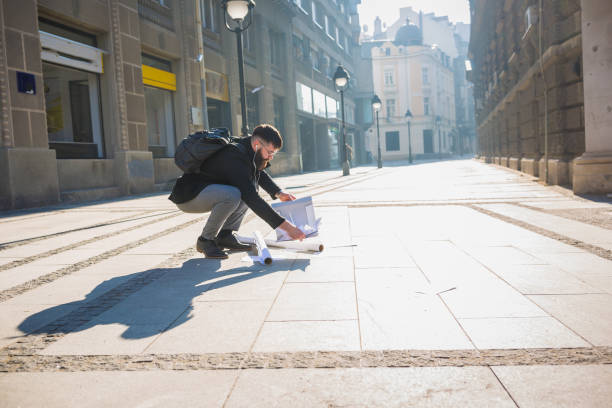 istock Papers spilling from businessman folder while he is rushing to the office 941412438