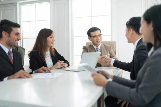 istock Business partners shaking hand after complete a deal. 941412838