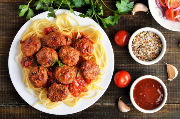 istock Meatballs and spaghetti on plate, tomato sauce and spice 941413688